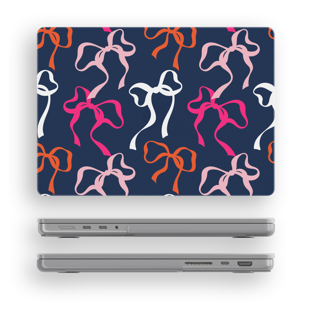 Navy blue MacBook case with bold colorful bows in pink, white, peach and orange – aesthetic girly tech cover for Air and Pro models