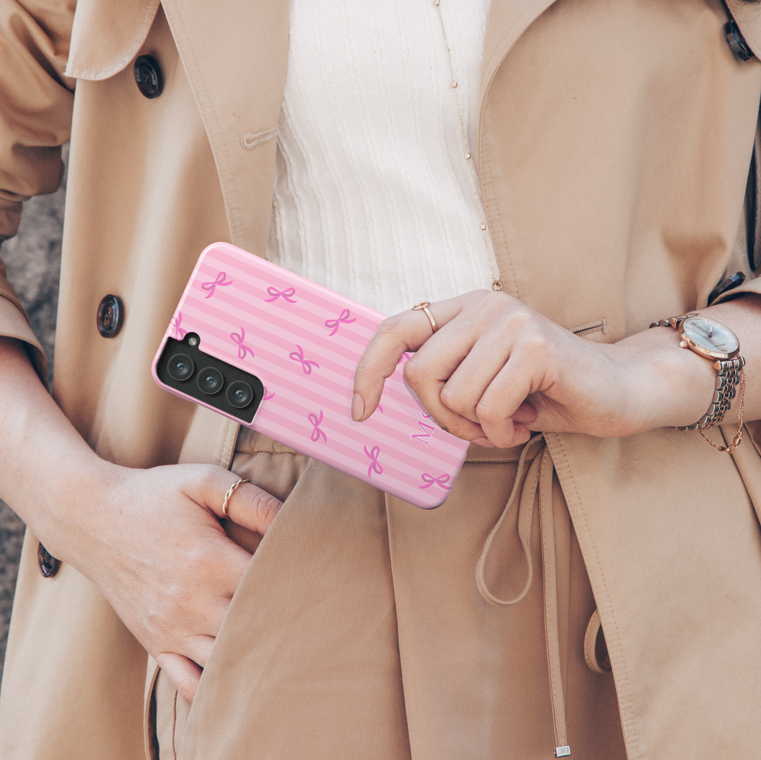 Samsung Galaxy phone case with pink vertical stripes and pink bows, customized with white monogram initials – girly aesthetic tough cover