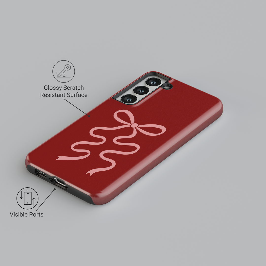 Deep red Samsung Galaxy phone case with soft pink ribbon bow – compatible with Galaxy S24 Ultra, S25, S24 FE. Elegant coquette aesthetic case for women.