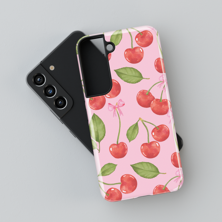 Cute Samsung Galaxy case with pink background, red cherry and white polka dot pattern – fits Galaxy S24 Ultra, S25, S24 FE. Girly cherry design with leaves and bow accents.