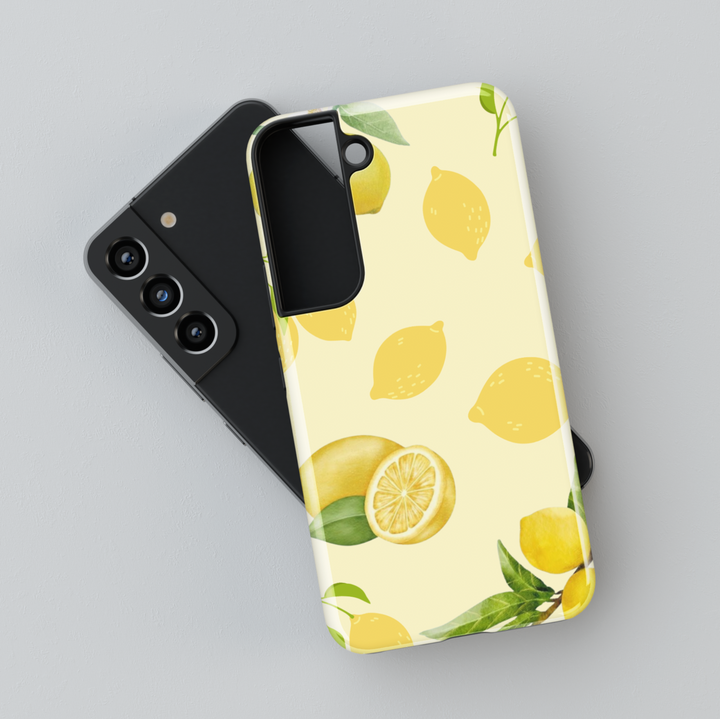 Samsung Galaxy phone case with watercolor lemon pattern and leaves on a light yellow background. Compatible with Galaxy S24 Ultra, S24 Plus, and S23 FE. Refreshing citrus design.