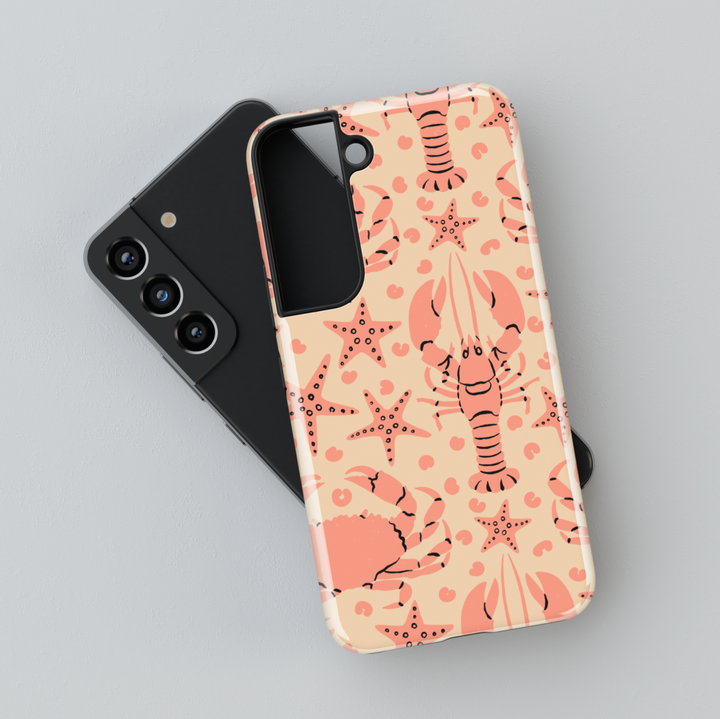 Samsung Galaxy case with coral lobster, crab, and starfish pattern on beige background – beach-themed design for Galaxy S24 Ultra, S25, and S24 FE.