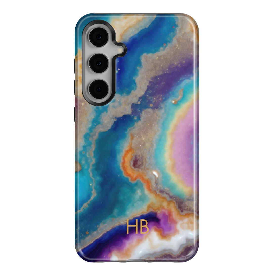 Samsung Galaxy S25 Ultra and S24FE tough phone case with galaxy geode marble design in blue, purple, orange, and gold, featuring personalized monogram.