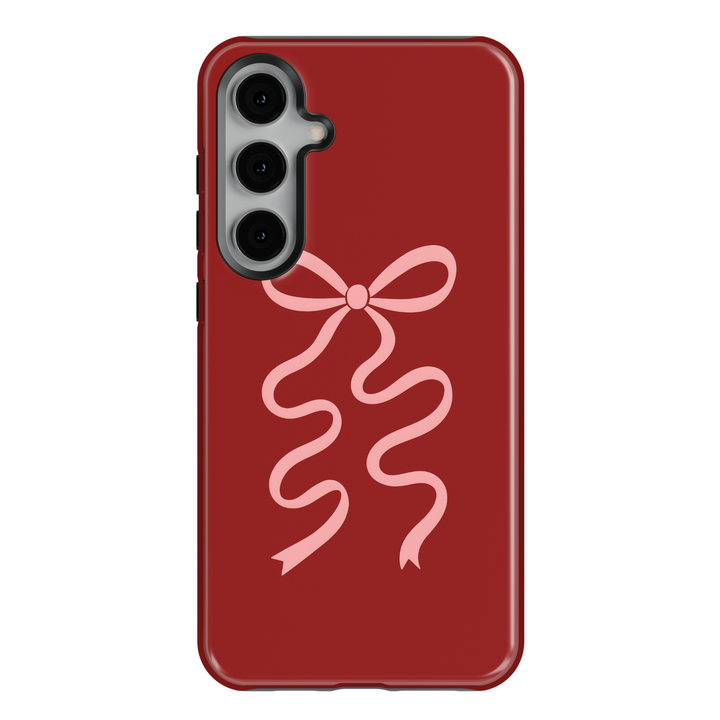 Deep red Samsung Galaxy phone case with soft pink ribbon bow – compatible with Galaxy S24 Ultra, S25, S24 FE. Elegant coquette aesthetic case for women.
