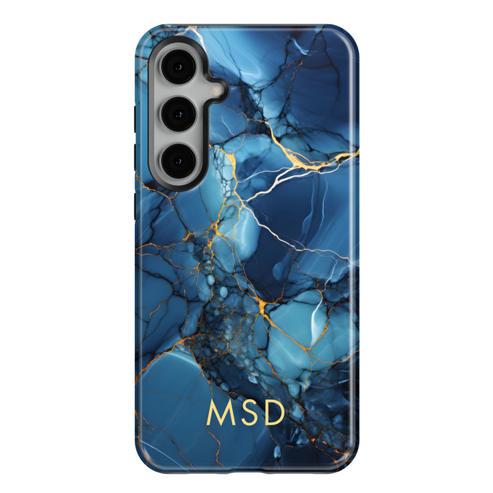 Samsung Galaxy S25 Ultra and S24FE tough phone case with deep blue marble design, gold veins, and custom monogram.