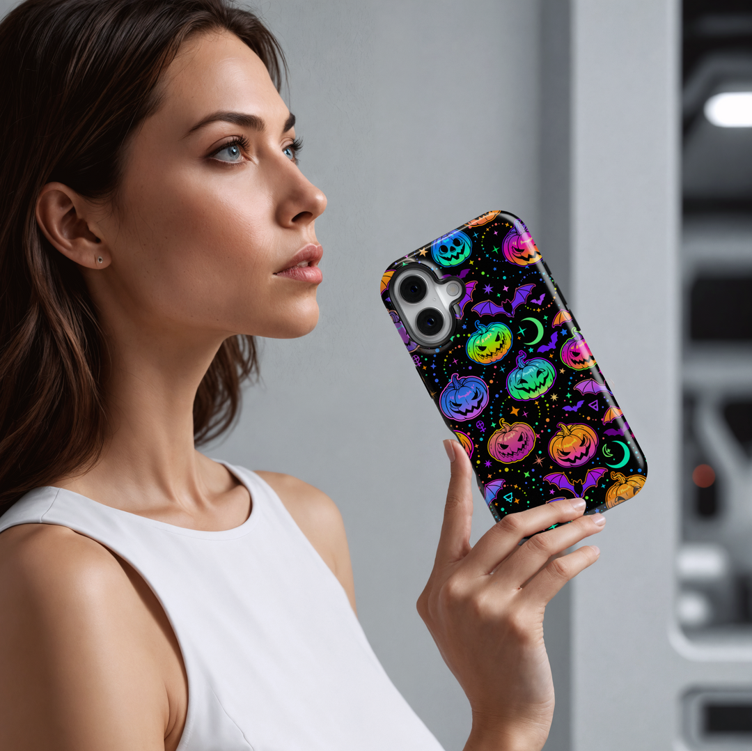 Colorful neon Halloween iPhone case with glowing rainbow pumpkins, bats, stars, moons, and spooky symbols on a black background. Features aesthetic spooky season vibes with vibrant jack-o'-lanterns, creepy bats, and a magical night sky design. Perfect for iPhone 16 Pro Max, 15, 14, and 13.