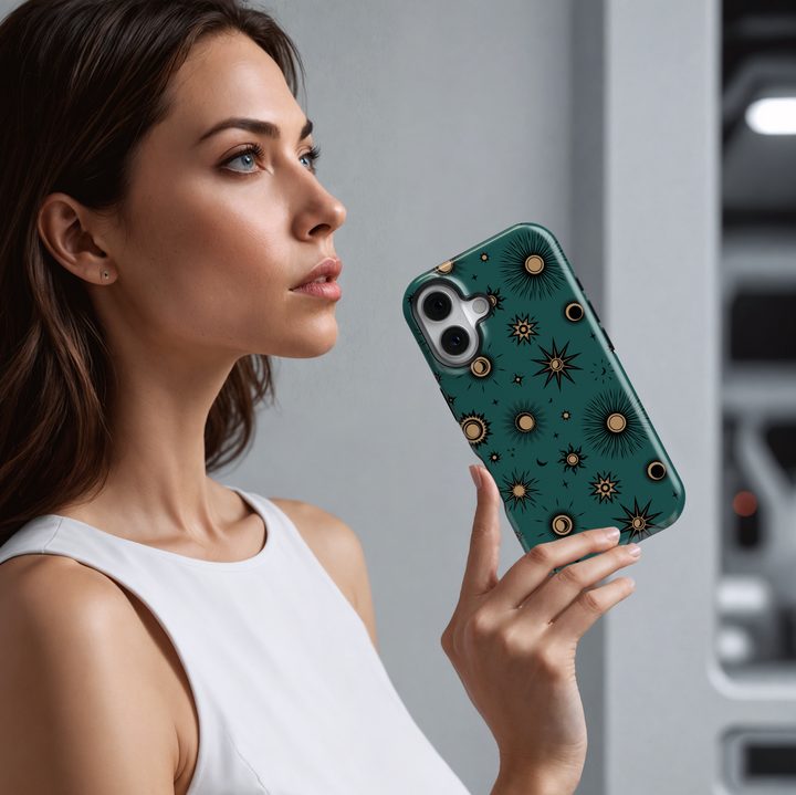 Teal iPhone case with mystical celestial pattern featuring gold-toned suns, moons, and stars in a vintage-style cosmic design.