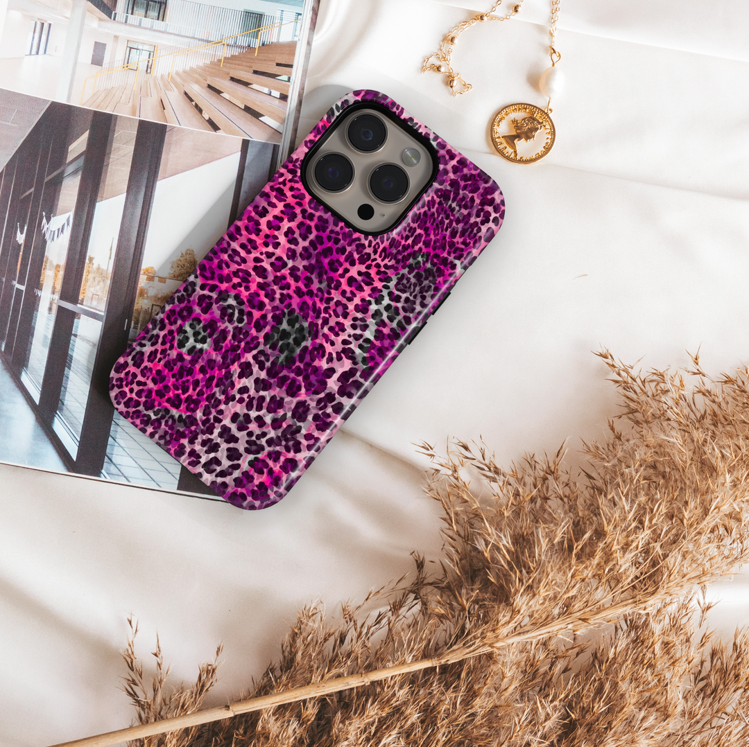 Hot pink leopard print phone case with purple and black animal spots, trendy chic aesthetic protective cover for iPhone and Samsung