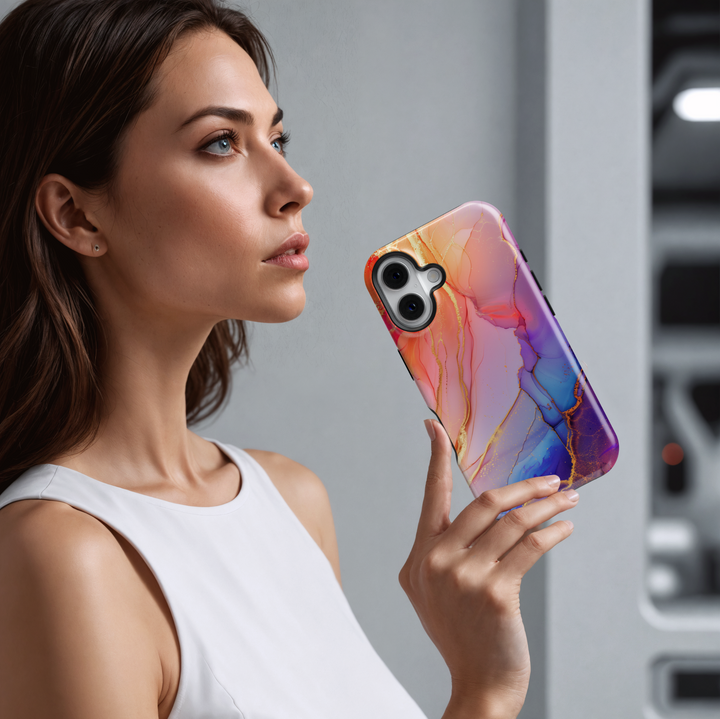 Elegant blush pink and violet marble swirl iPhone 16 MagSafe case with gold accents and fluid abstract design.