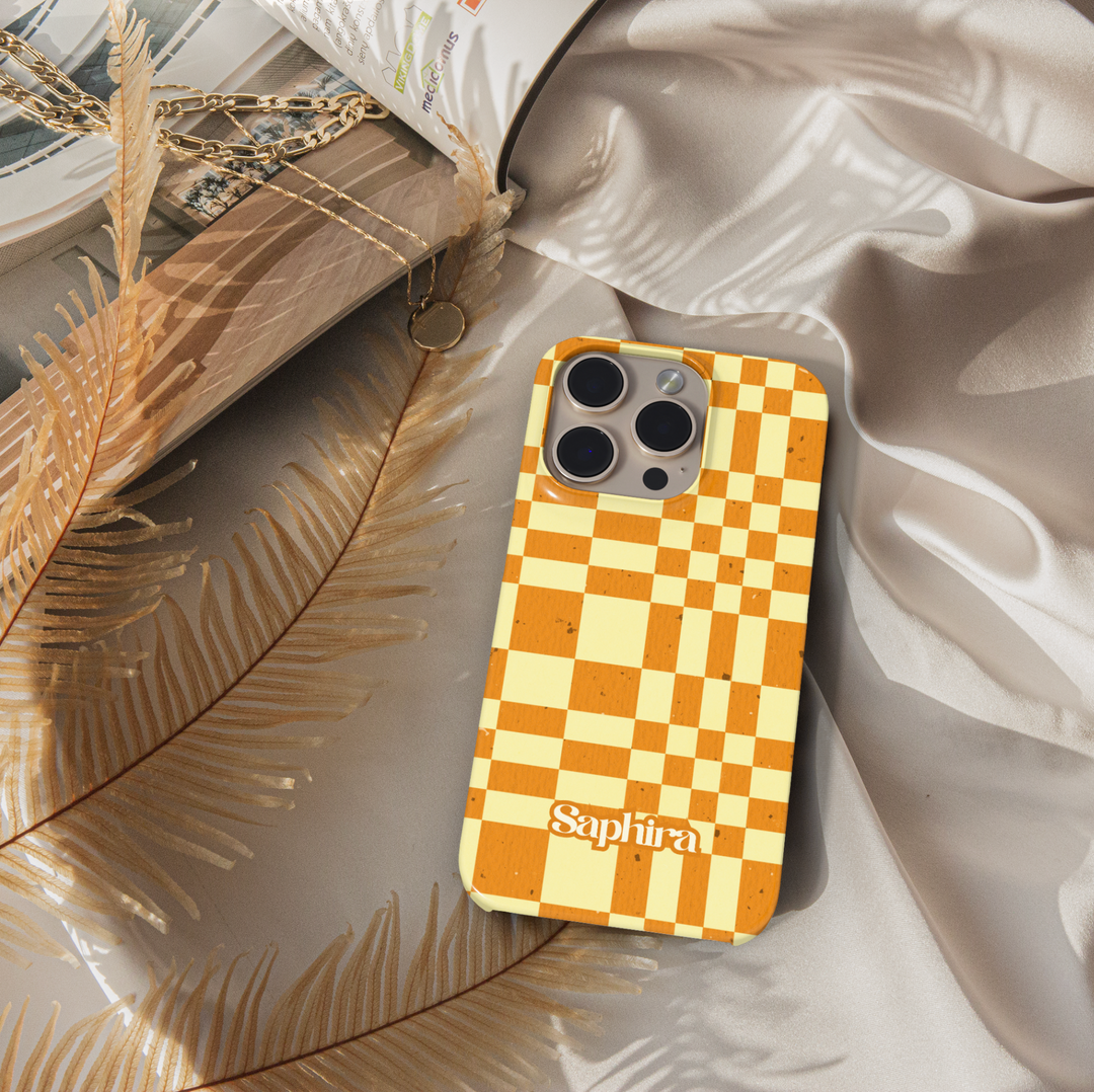 Orange and cream plaid iPhone case with oversized checkerboard pattern, warm autumn aesthetic phone cover, trendy retro grid iPhone 15, iPhone 14, iPhone 13 Pro Max case.