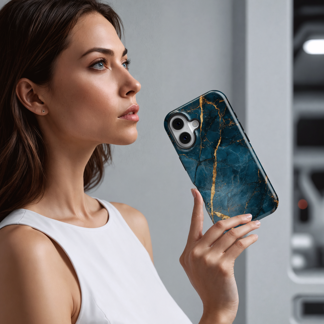 Elegant iPhone case with deep blue marble texture and gold vein detailing; MagSafe-compatible tough case for iPhone 16.
