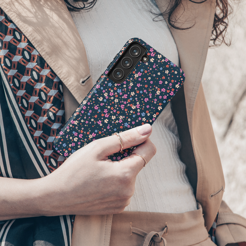 Galaxy phone case with tiny multicolored floral print on dark navy background – aesthetic garden-style design