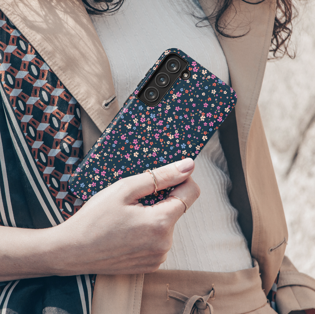 Galaxy phone case with tiny multicolored floral print on dark navy background – aesthetic garden-style design
