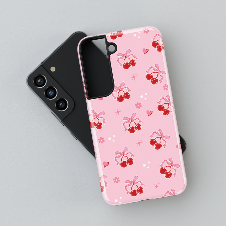 Coquette pink Samsung Galaxy case with red cherries, heart bows, and floral accents – cute girly aesthetic protective phone cover