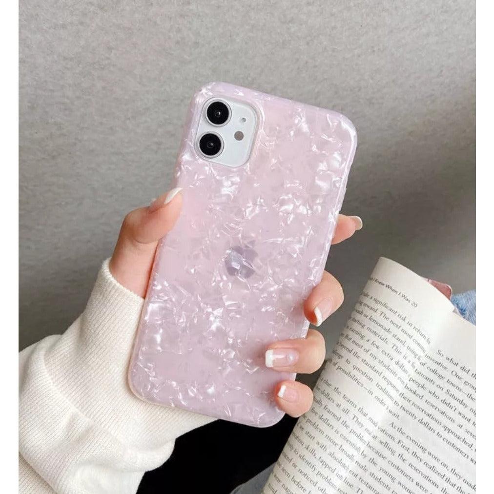 Glossy pearl pink iPhone case with a luxurious shimmer shell texture, designed for a stylish and protective fit.