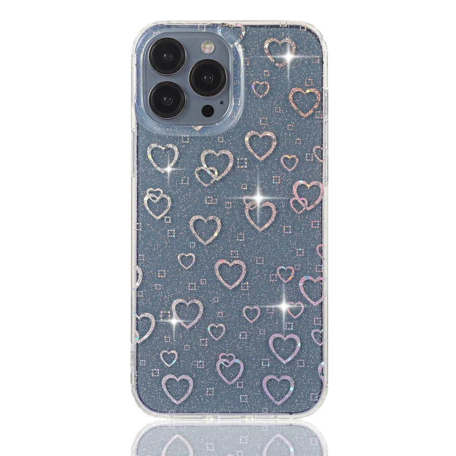 Stylish clear iPhone case featuring a dazzling holographic heart pattern with glitter details. The case catches the light beautifully, creating a mesmerizing sparkle effect. Designed for both style and protection, this case keeps your phone safe while adding a trendy and eye-catching touch. Perfect for those who love a little shimmer in their everyday accessories.