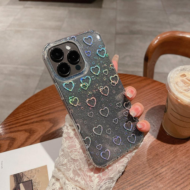 Stylish clear iPhone case featuring a dazzling holographic heart pattern with glitter details. The case catches the light beautifully, creating a mesmerizing sparkle effect. Designed for both style and protection, this case keeps your phone safe while adding a trendy and eye-catching touch. Perfect for those who love a little shimmer in their everyday accessories.