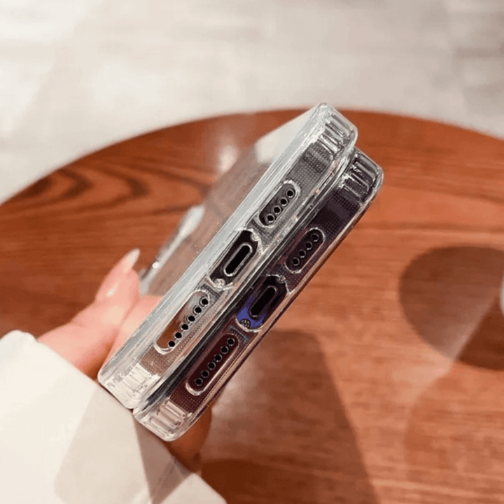 Stylish clear iPhone case featuring a dazzling holographic heart pattern with glitter details. The case catches the light beautifully, creating a mesmerizing sparkle effect. Designed for both style and protection, this case keeps your phone safe while adding a trendy and eye-catching touch. Perfect for those who love a little shimmer in their everyday accessories.