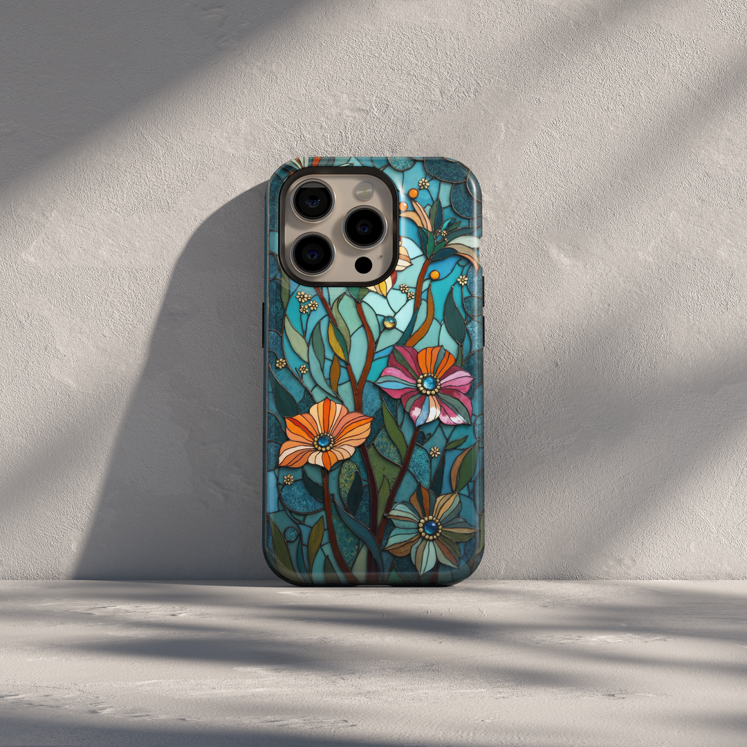 Teal stained glass iPhone case with floral patterns, leafy stems, and warm accent colors in an elegant artistic design