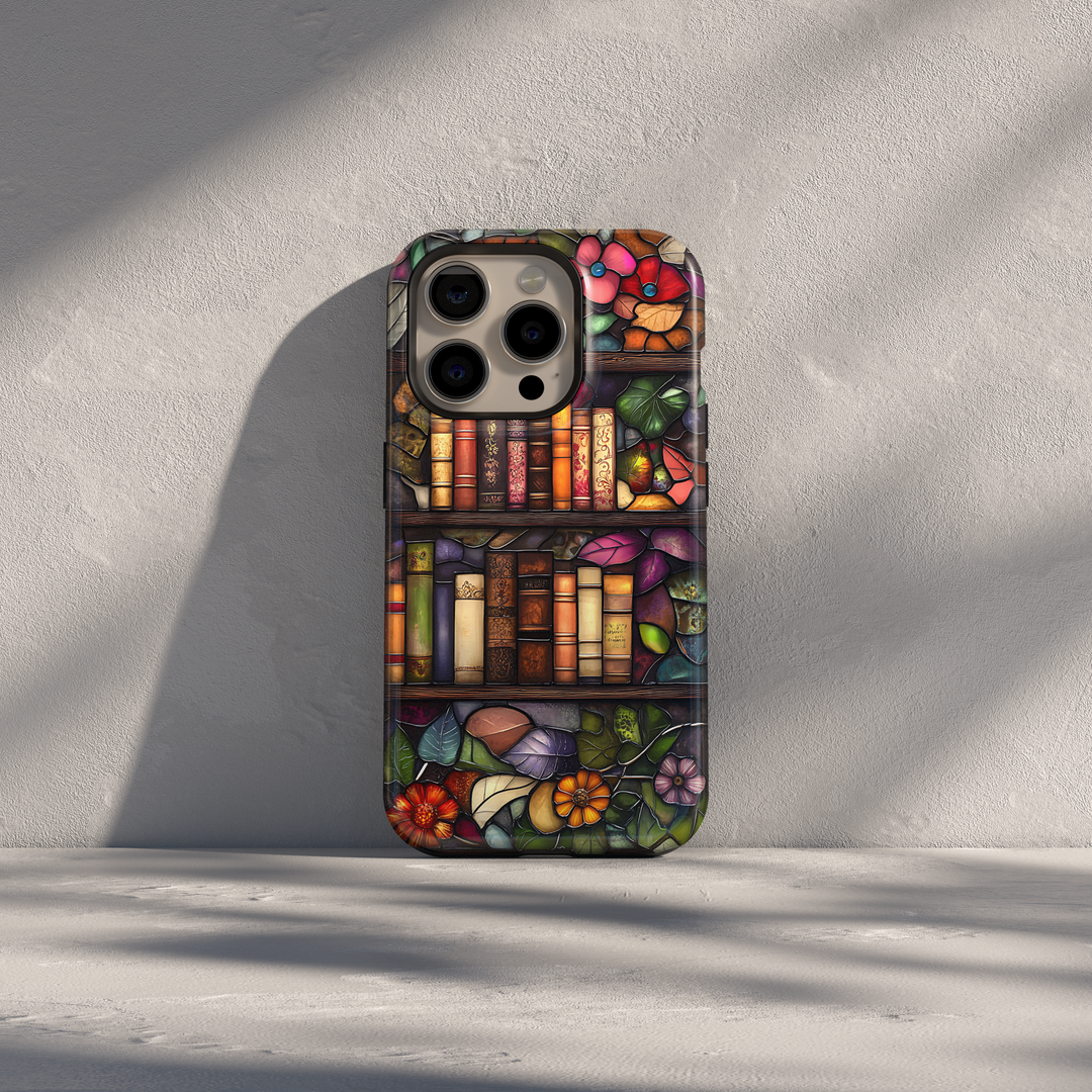 Stained glass style iPhone case with vintage bookshelves, floral leaves, and warm artistic tones in an elegant library-inspired design
