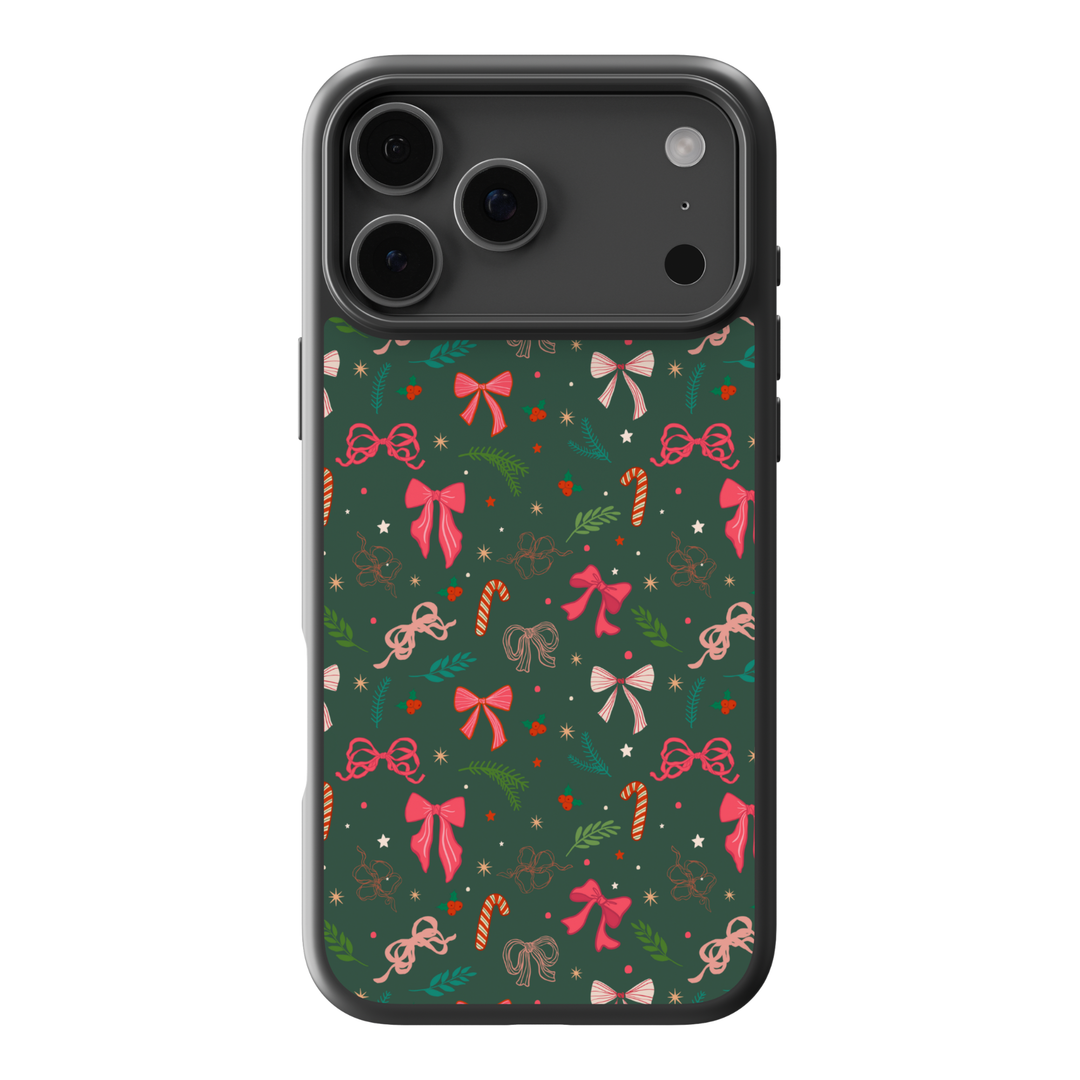 Green Christmas phone case with pink and red bows, candy canes, holly leaves, and festive holiday pattern