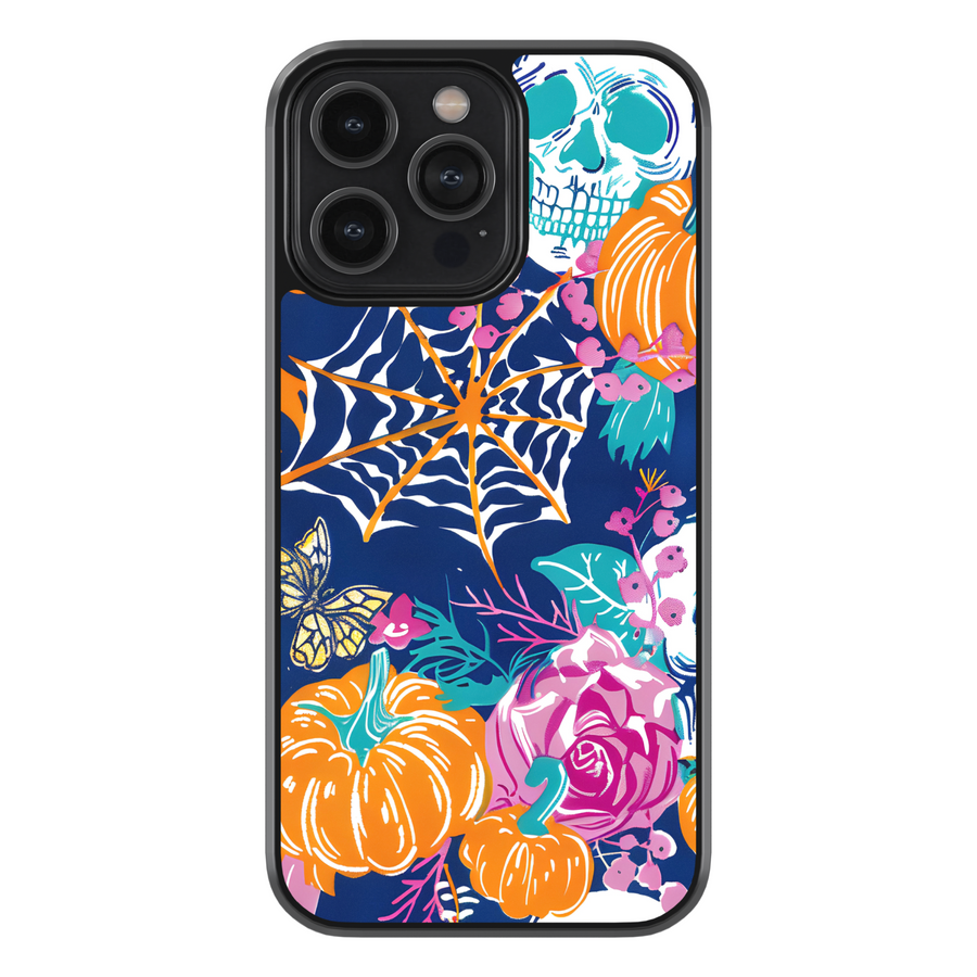 Midnight Bloom iPhone case with pumpkins, skull, spider web, and colorful floral design on navy background.
