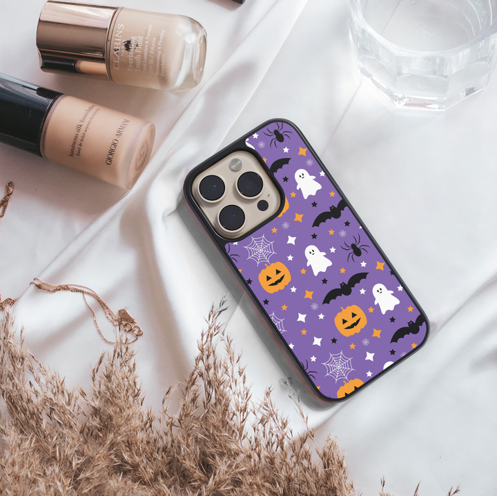 Purple Halloween phone case with ghosts, pumpkins, bats, spiders, and stars.
