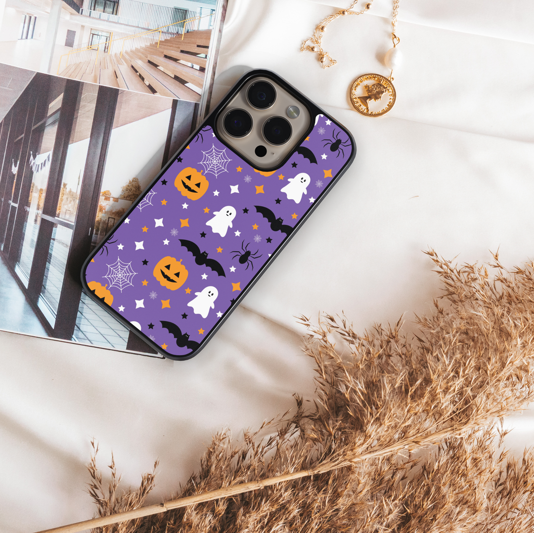 Purple Halloween phone case with ghosts, pumpkins, bats, spiders, and stars.