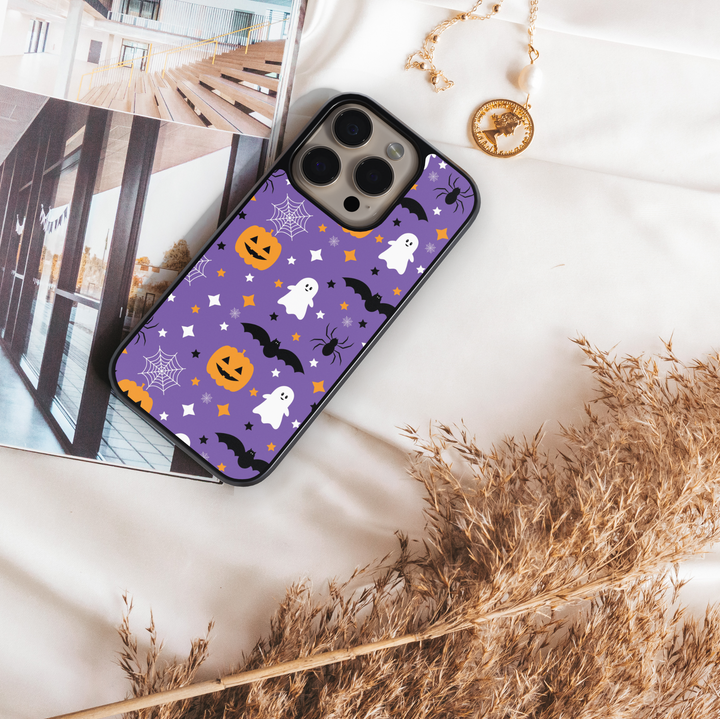 Purple Halloween phone case with ghosts, pumpkins, bats, spiders, and stars.