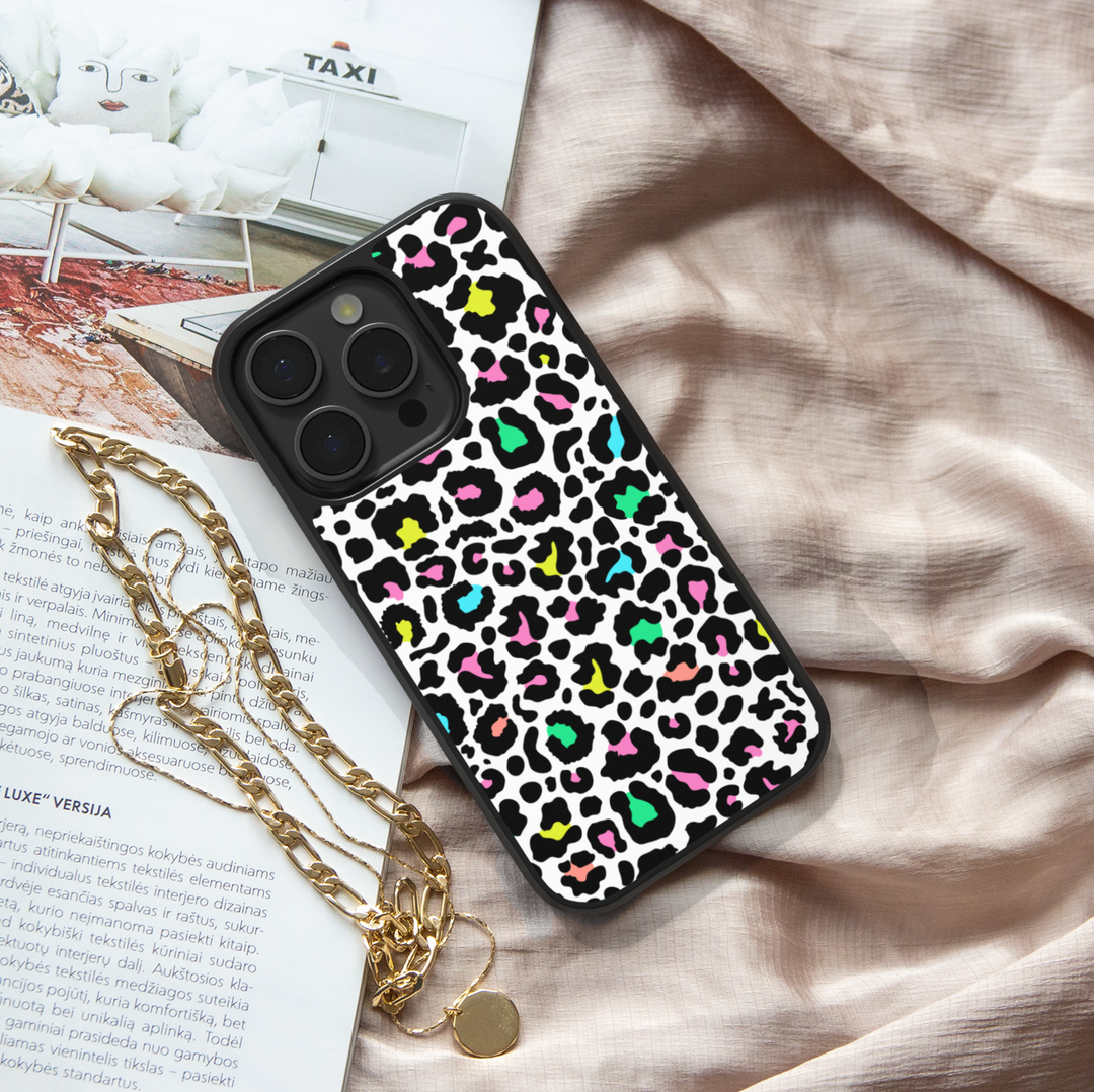 iPhone case with colorful neon leopard print design in pink, green, yellow, and teal on a white background – trendy girly protective phone cover.