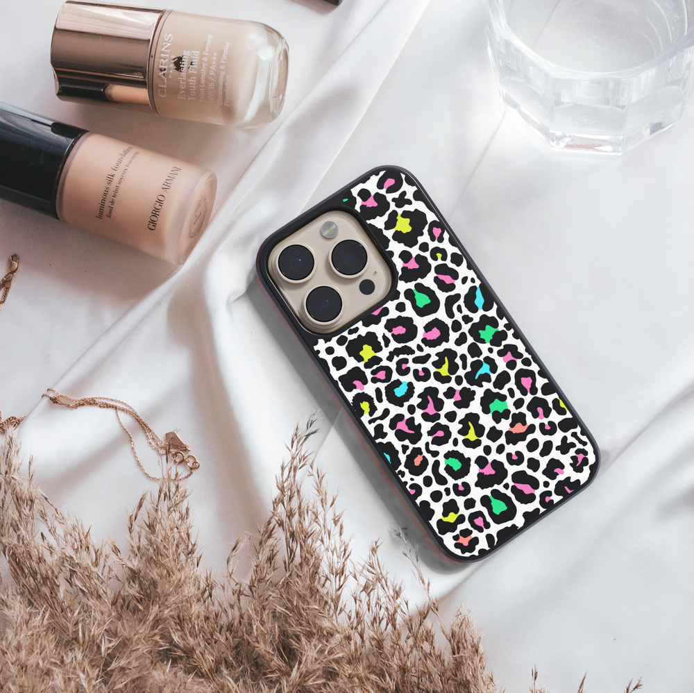 iPhone case with colorful neon leopard print design in pink, green, yellow, and teal on a white background – trendy girly protective phone cover.
