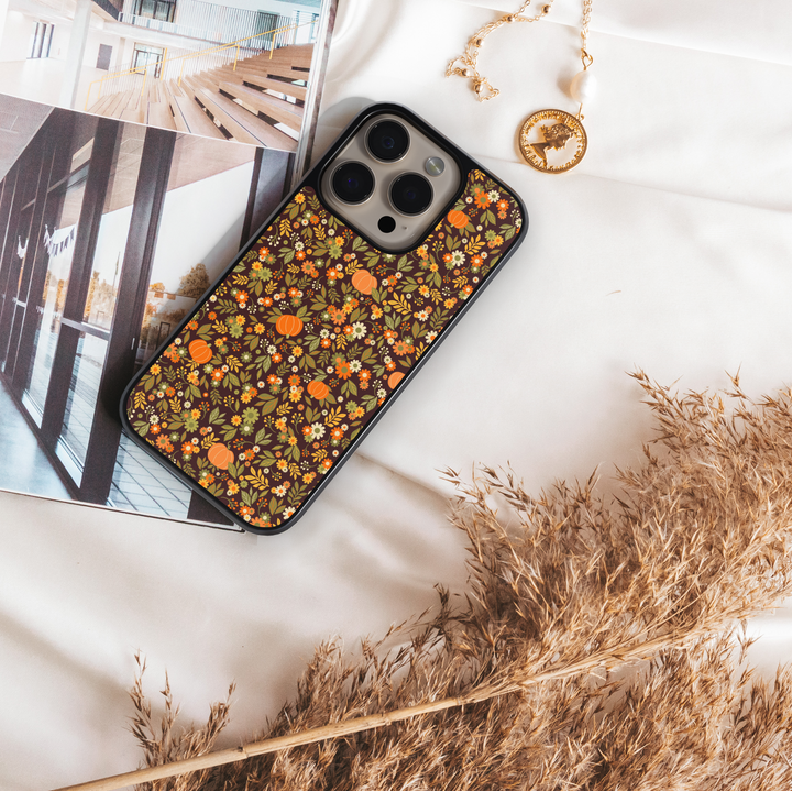 iPhone case with chic pumpkin and floral pattern in warm autumn tones – girly fall aesthetic design.