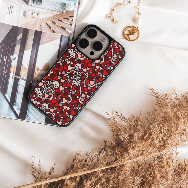 Hearts Skeleton iPhone Case, Halloween iPhone cover with spooky skeletons and pumpkin heads, cute gothic phone case with black background, protective fall phone case, stylish skeleton iPhone cover