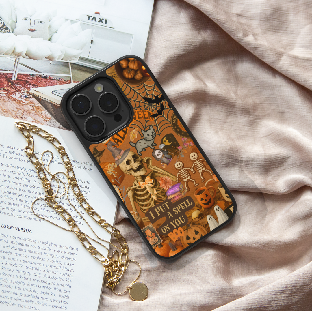 Halloween iPhone case with vintage collage design, spooky skeleton, pumpkins, ghosts, cobwebs, witch hat, retro orange background, aesthetic spooky cute Halloween phone cover