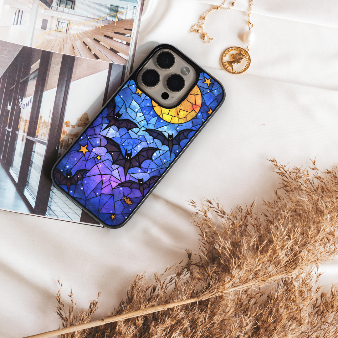 Stained glass Halloween iPhone case with moon, flying bats, stars, gothic aesthetic, spooky night phone cover, protective case for iPhone.