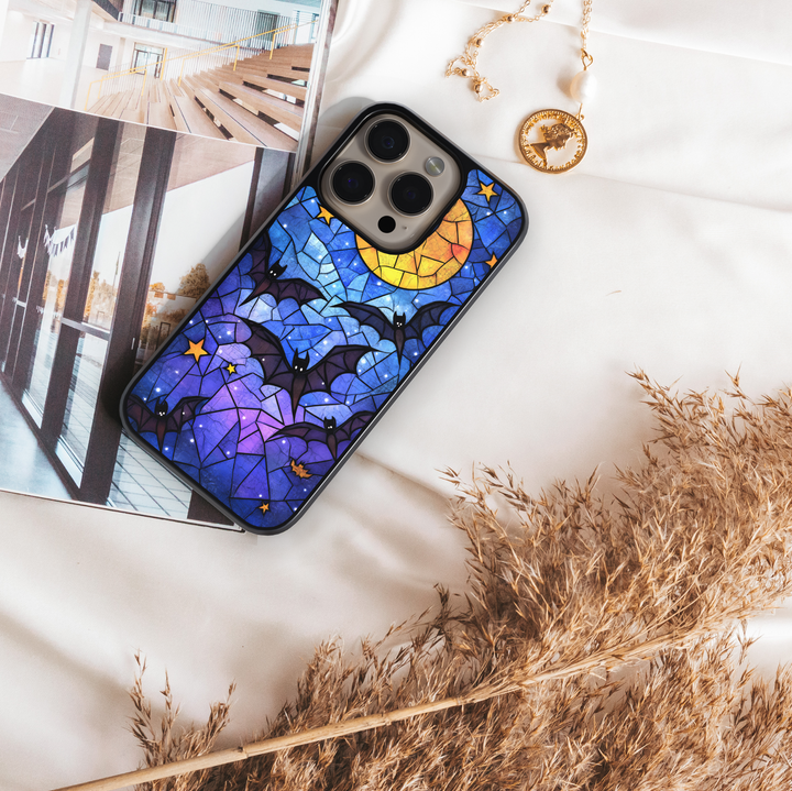 Stained glass Halloween iPhone case with moon, flying bats, stars, gothic aesthetic, spooky night phone cover, protective case for iPhone.