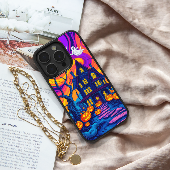 Halloween haunted house phone case with glowing pumpkins, ghosts, bats, and colorful night sky – spooky protective iPhone and Samsung Galaxy cover for Halloween aesthetic
