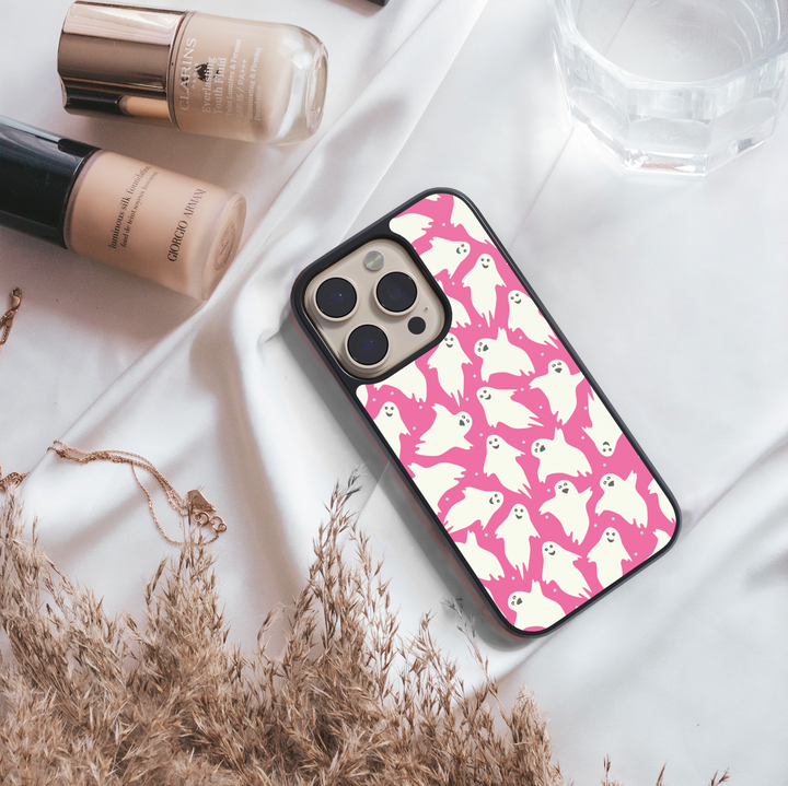 Girly pink Halloween iPhone case with spider webs, pumpkins, and cute spooky design.