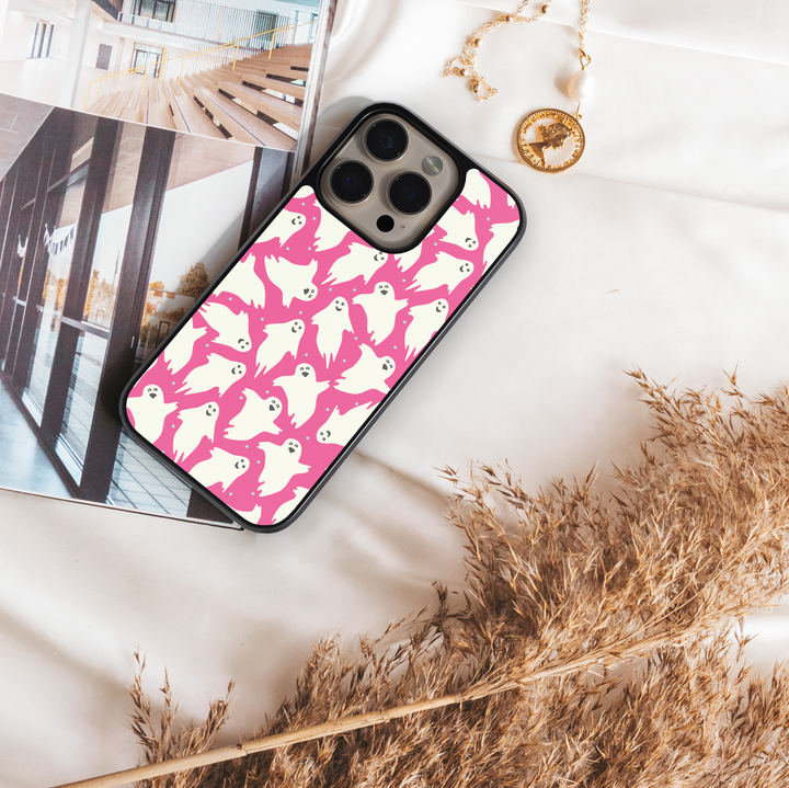 Girly pink Halloween iPhone case with spider webs, pumpkins, and cute spooky design.