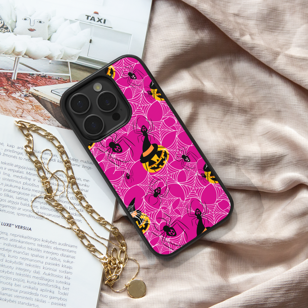 Girly pink Halloween iPhone case with spider webs, pumpkins, and cute spooky design.
