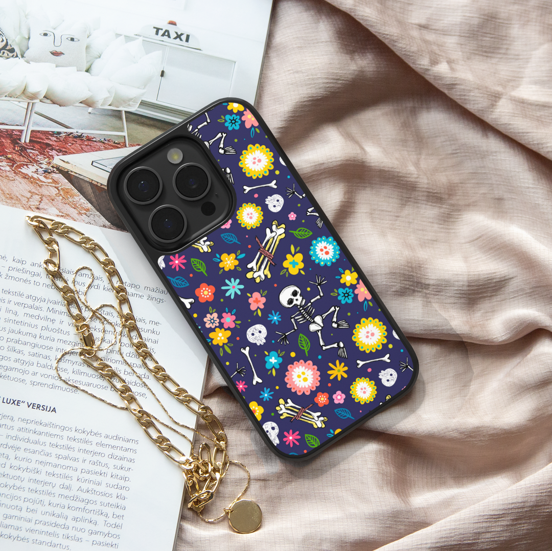Skeleton floral Halloween phone case with colorful flowers, skulls, and bones on dark navy background – protective iPhone and Samsung cover