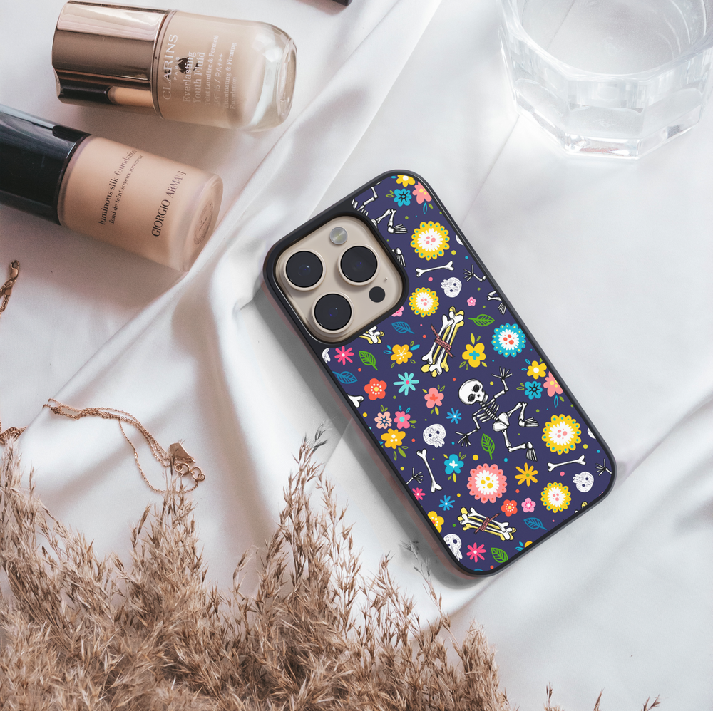 Skeleton floral Halloween phone case with colorful flowers, skulls, and bones on dark navy background – protective iPhone and Samsung cover