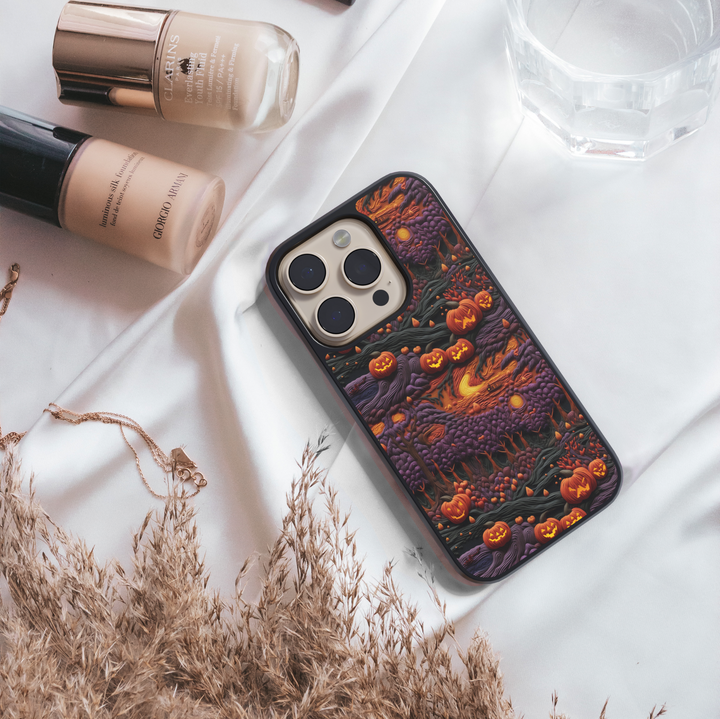 Halloween iPhone case with glowing pumpkins, jack-o’-lantern forest design, spooky purple trees, haunted night sky, protective phone cover for iPhone, aesthetic fall and Halloween accessory.