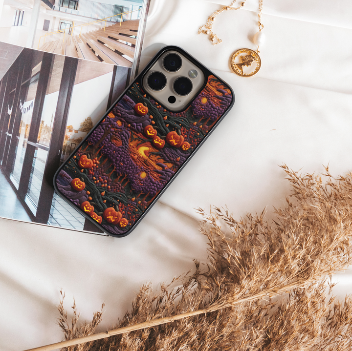 Halloween iPhone case with glowing pumpkins, jack-o’-lantern forest design, spooky purple trees, haunted night sky, protective phone cover for iPhone, aesthetic fall and Halloween accessory.