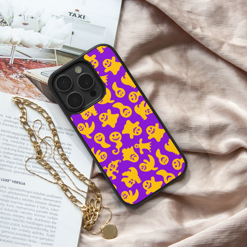 Halloween pumpkin and witch hat iPhone case with ghost, bat, and star pattern on cream background.