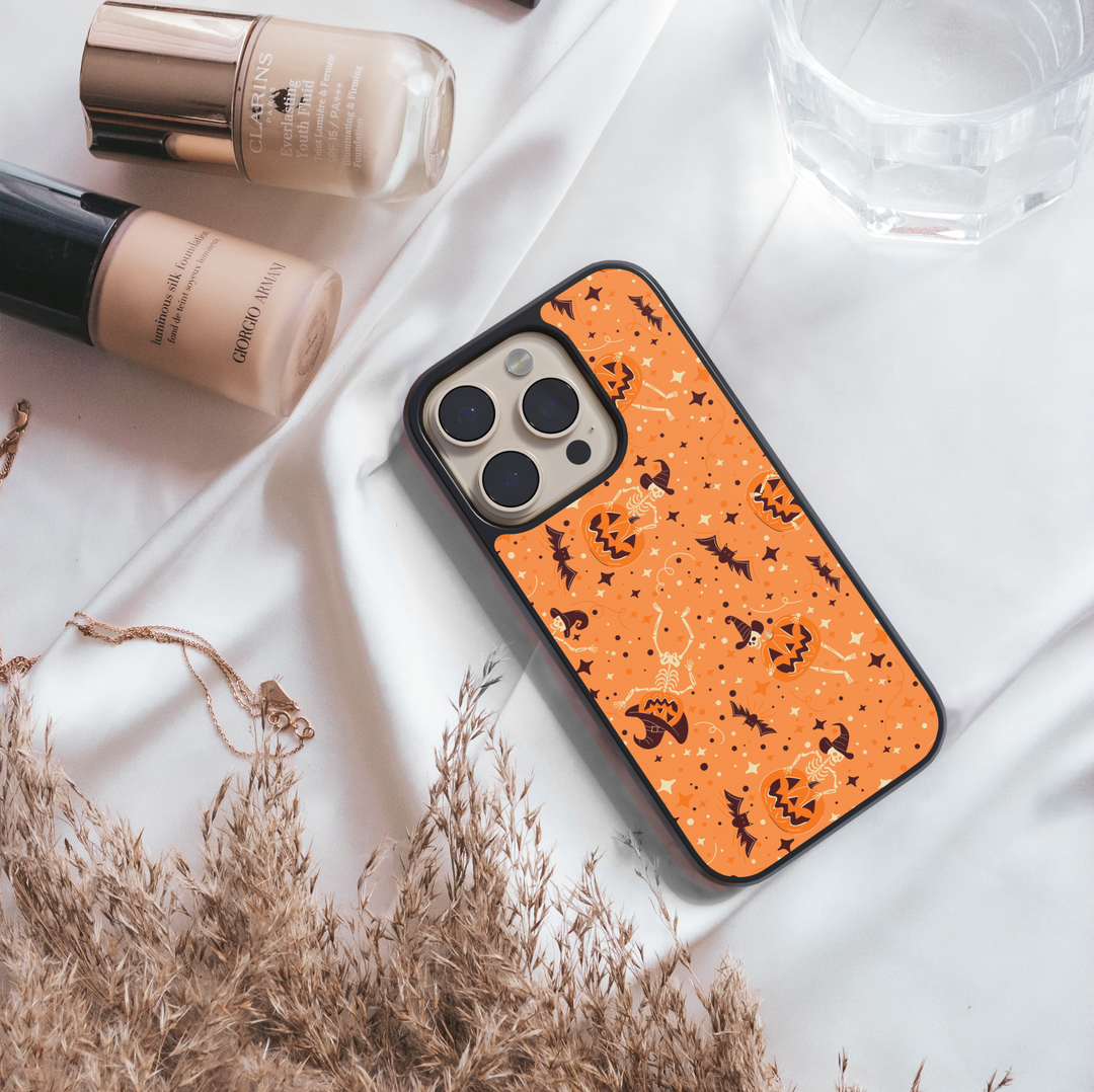 Orange pumpkin skeleton iPhone case with bats, witch hats, and Halloween stars – spooky cute protective phone cover for iPhone.