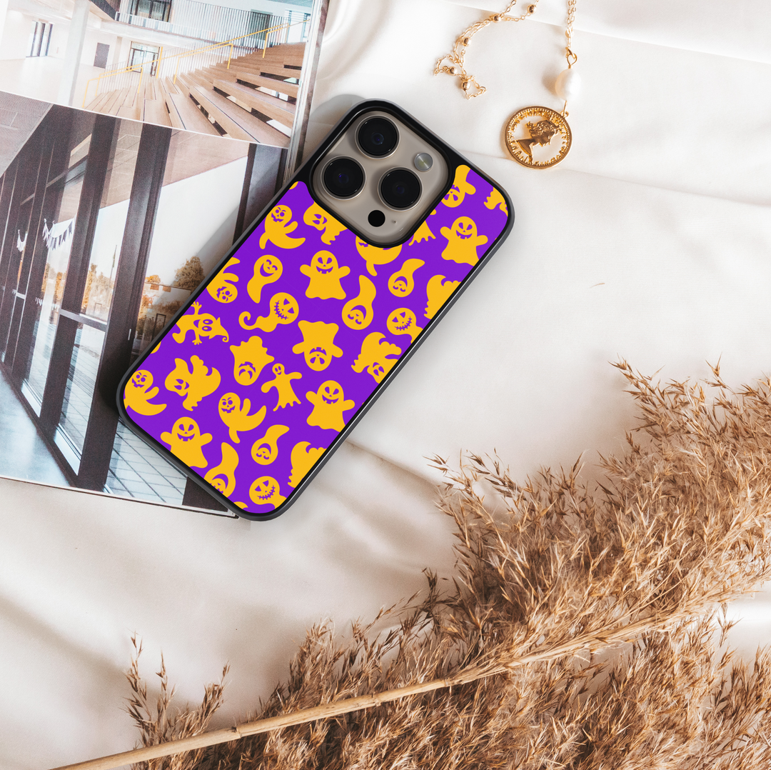 Halloween pumpkin and witch hat iPhone case with ghost, bat, and star pattern on cream background.