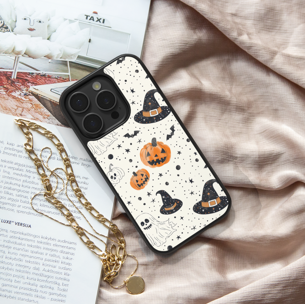 Halloween pumpkin and witch hat iPhone case with ghost, bat, and star pattern on cream background.