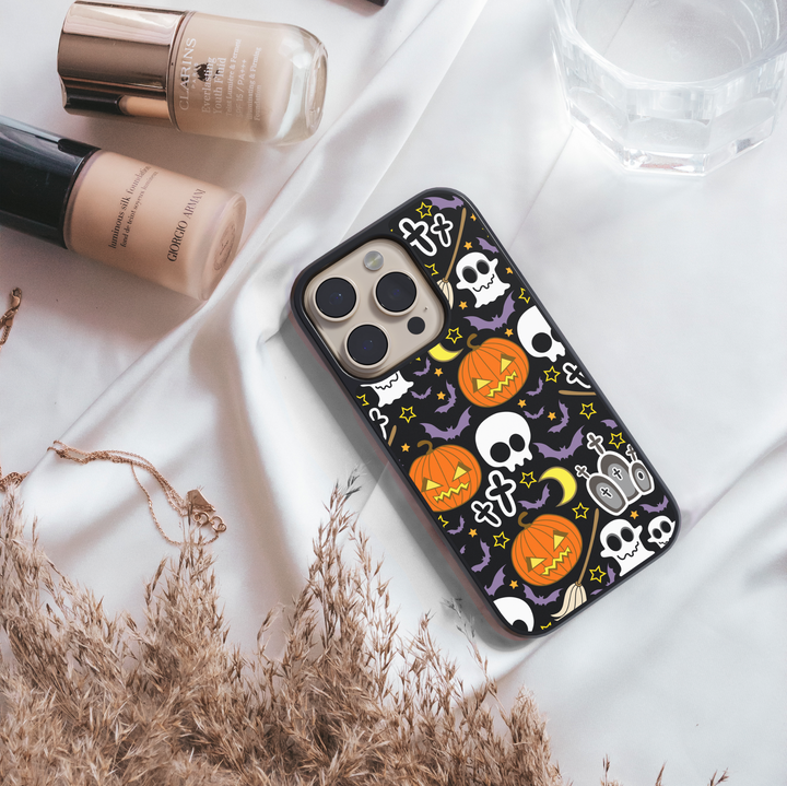 Halloween iPhone tough case with pumpkins, skulls, bats, and spooky cute illustrations on black background.