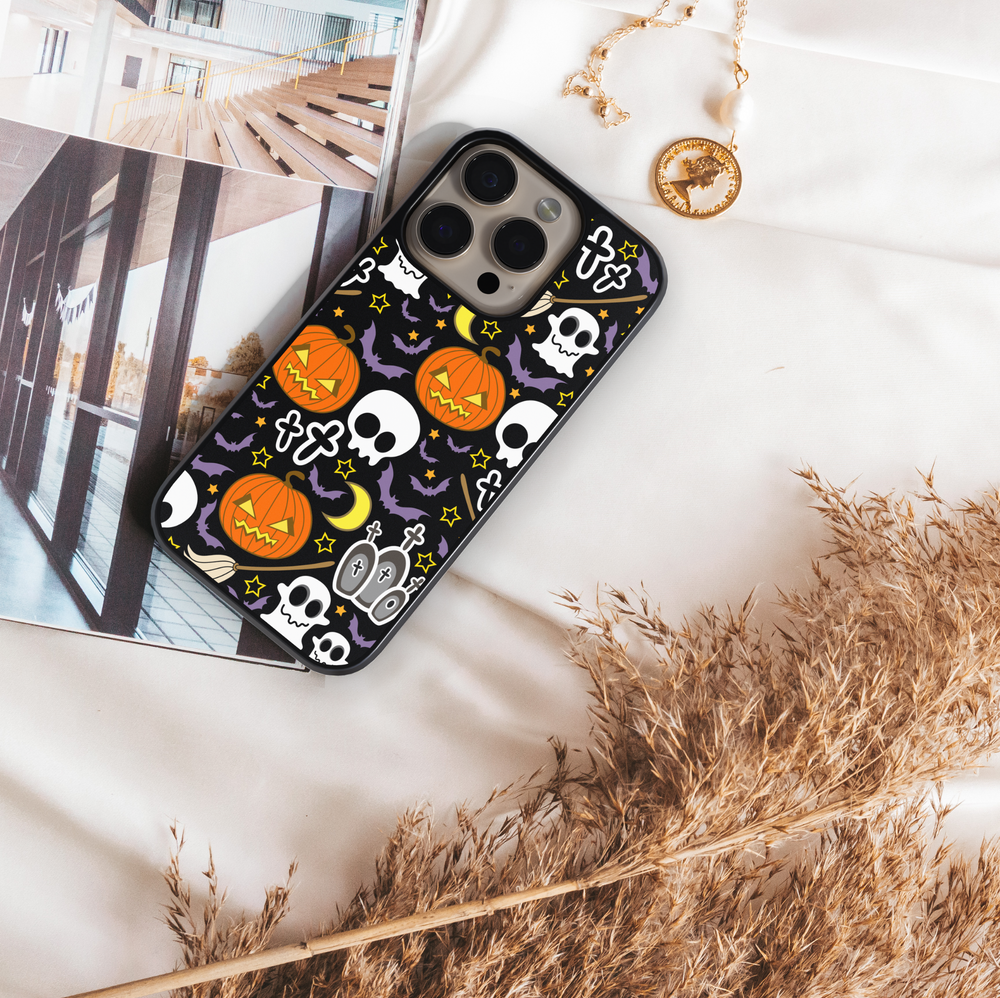 Halloween iPhone tough case with pumpkins, skulls, bats, and spooky cute illustrations on black background.